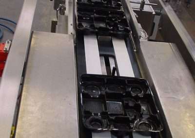 Product conveyors carrying trays